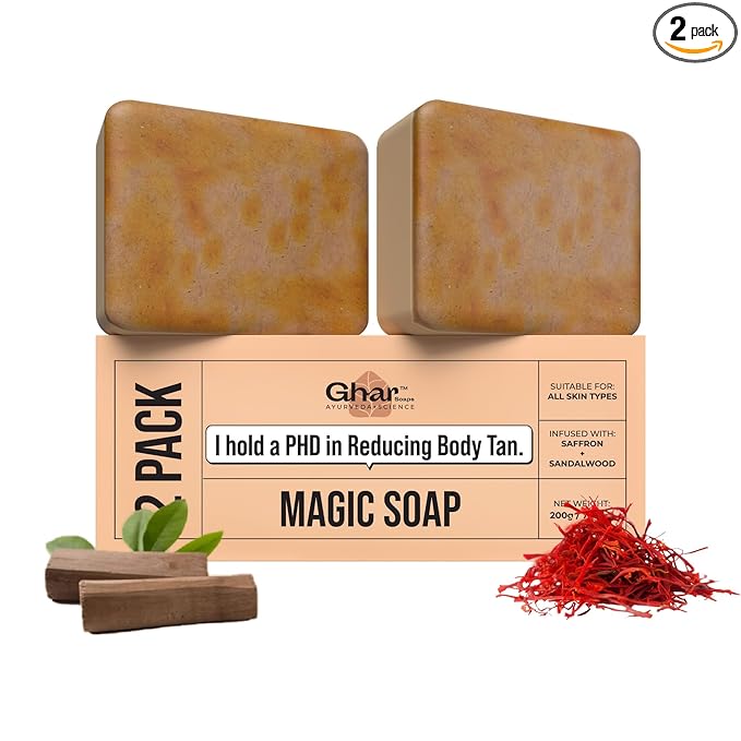 Luxury GHAR Soap placed on a spa towel with saffron and goat milk beside it